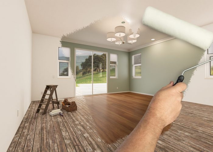 Before and After of Man Painting Roller to Reveal Newly Remodeled Room with Fresh Light Green Paint and New Floors.